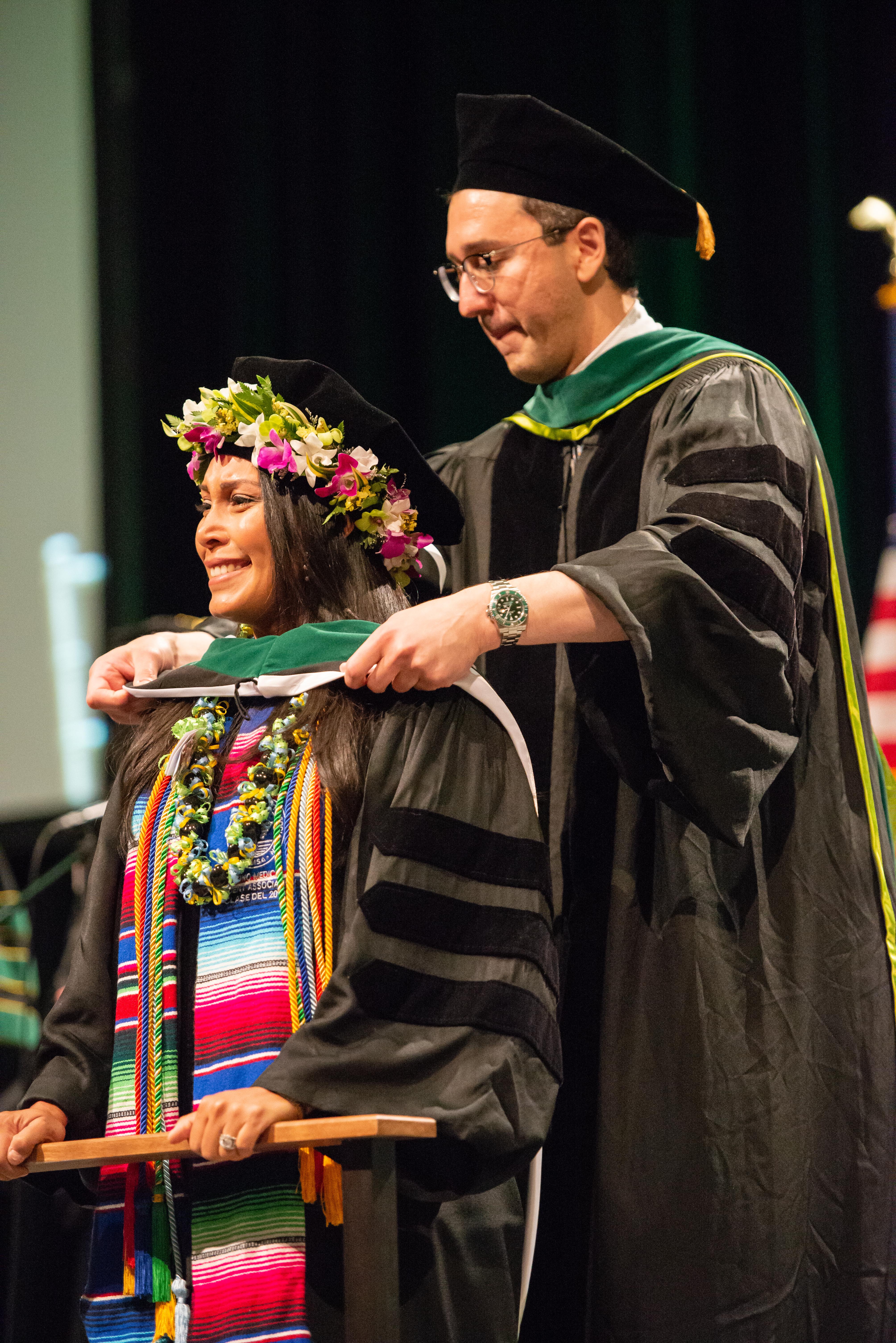 SOM M.D. hooding ceremony student speaker Nattaly Greene hooded by Dr. David Mansoor