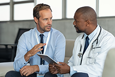 Healthcare workers talking together on a couch.