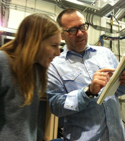 Woman and man looking at a clipboard