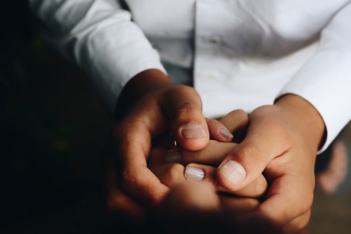 Closeup of two people holding hands