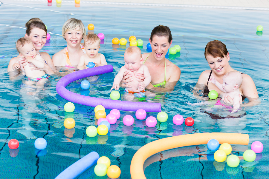 Moms and newborns playing in a pool