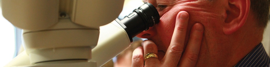 Man looking into microscope