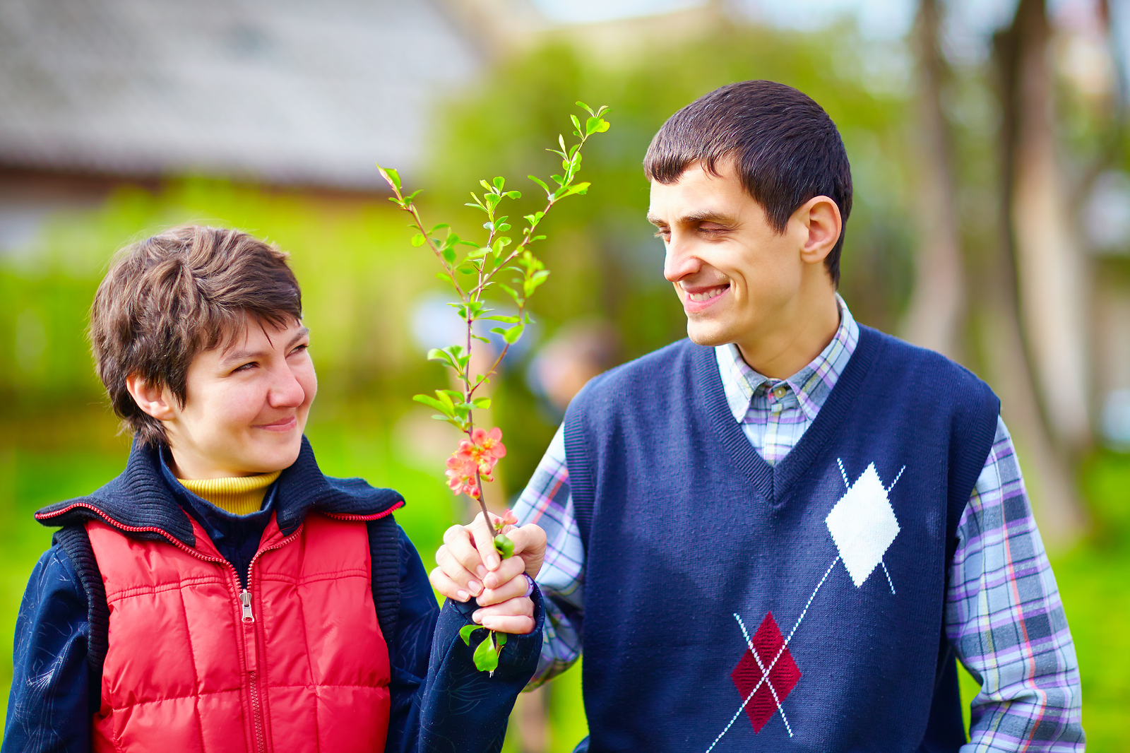 Couple walking outside holding flowering tree branch