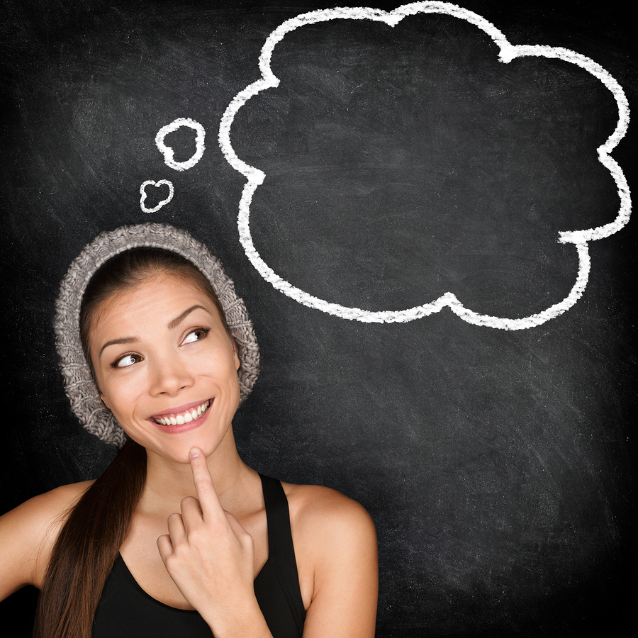Woman with a thought bubble behind her on a blackboard