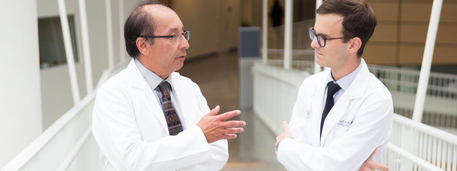 Dr. Charles Lopez and physician assistant Jeff Donovan, talking