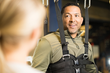 Rehab services specialist and patient using lokomat device