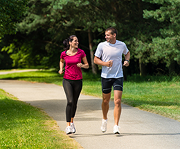 Woman and man running in park