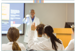 Students sitting in a classroom asking questions