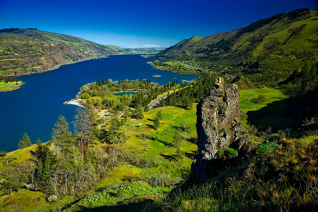 Very green, western area of the Columbia River Gorge with rock outcroppings