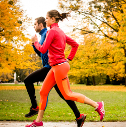 Couple running together outdoors