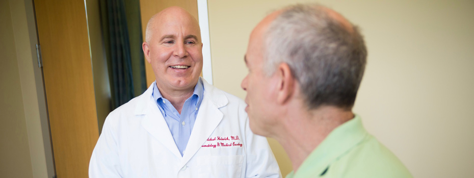 Dr. Michael Heinrich and a patient warmly converse in an examination room