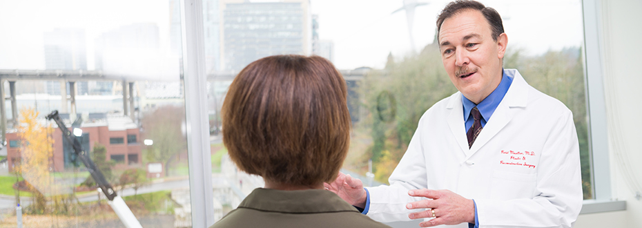 Dr. Reid Mueller, a pioneer in minimally invasive methods, discusses treatment options with a patient.