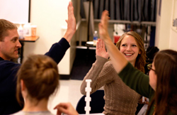 Smiling students high five