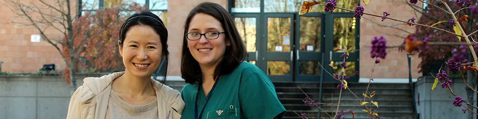 Smiling nursing students in front of school
