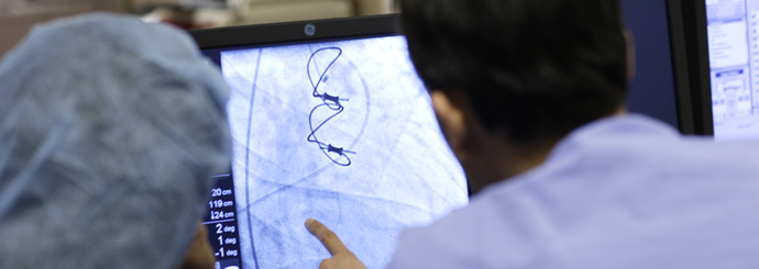 Specialists in interventional cardiology reviewing imaging.