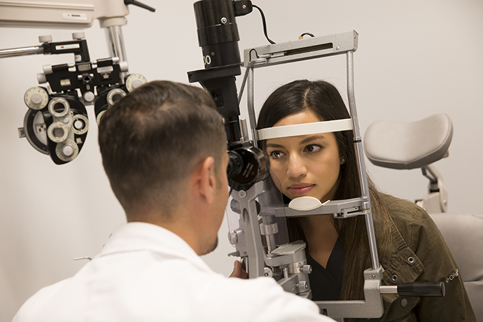Patient having eyes examined by the doctor.