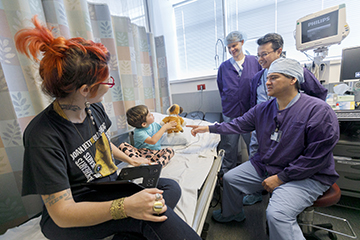 Child and parent with doctors before eye surgery