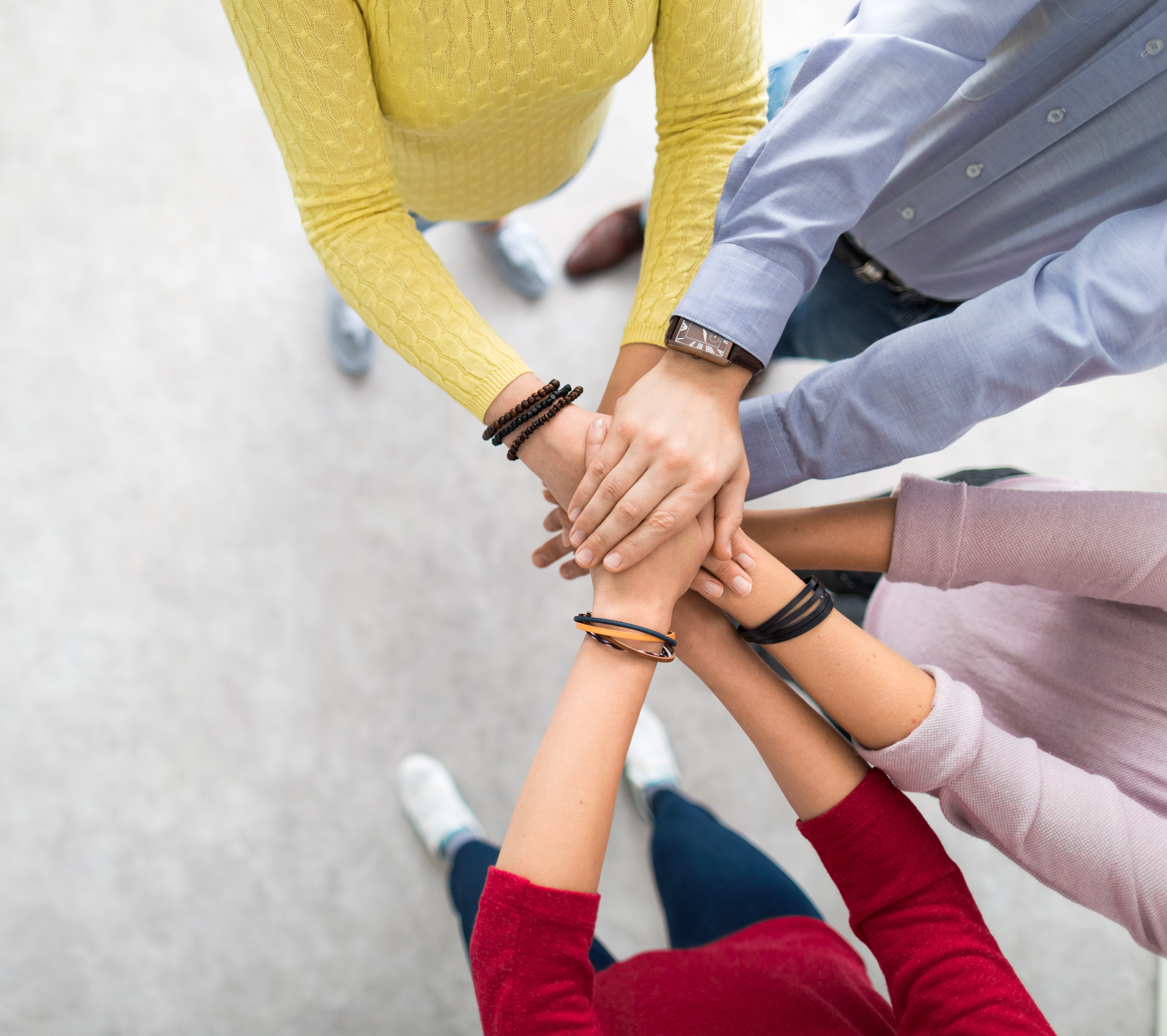 Overlapping hands in a huddle