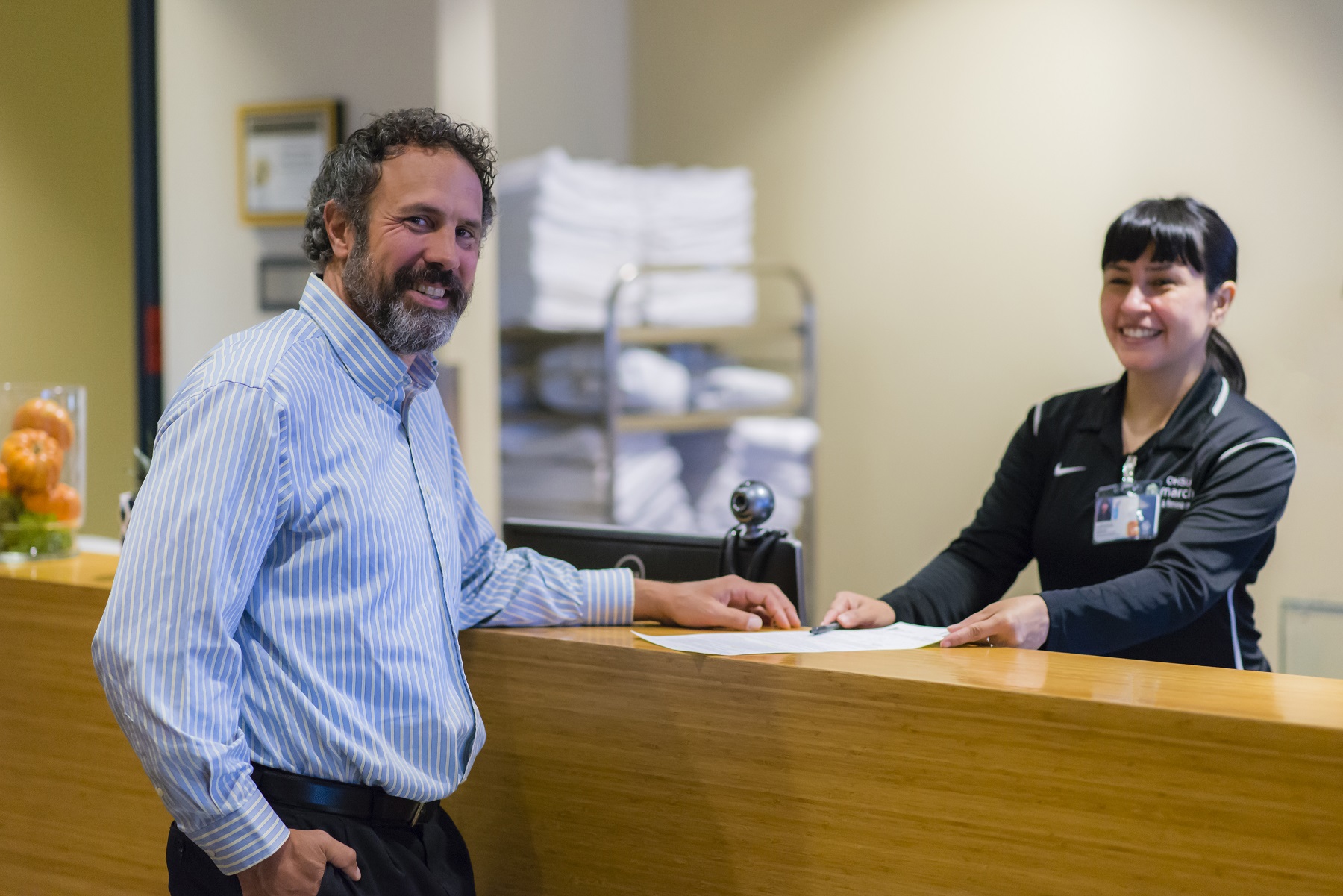 Member greeted at front desk by march wellness & fitness staff.