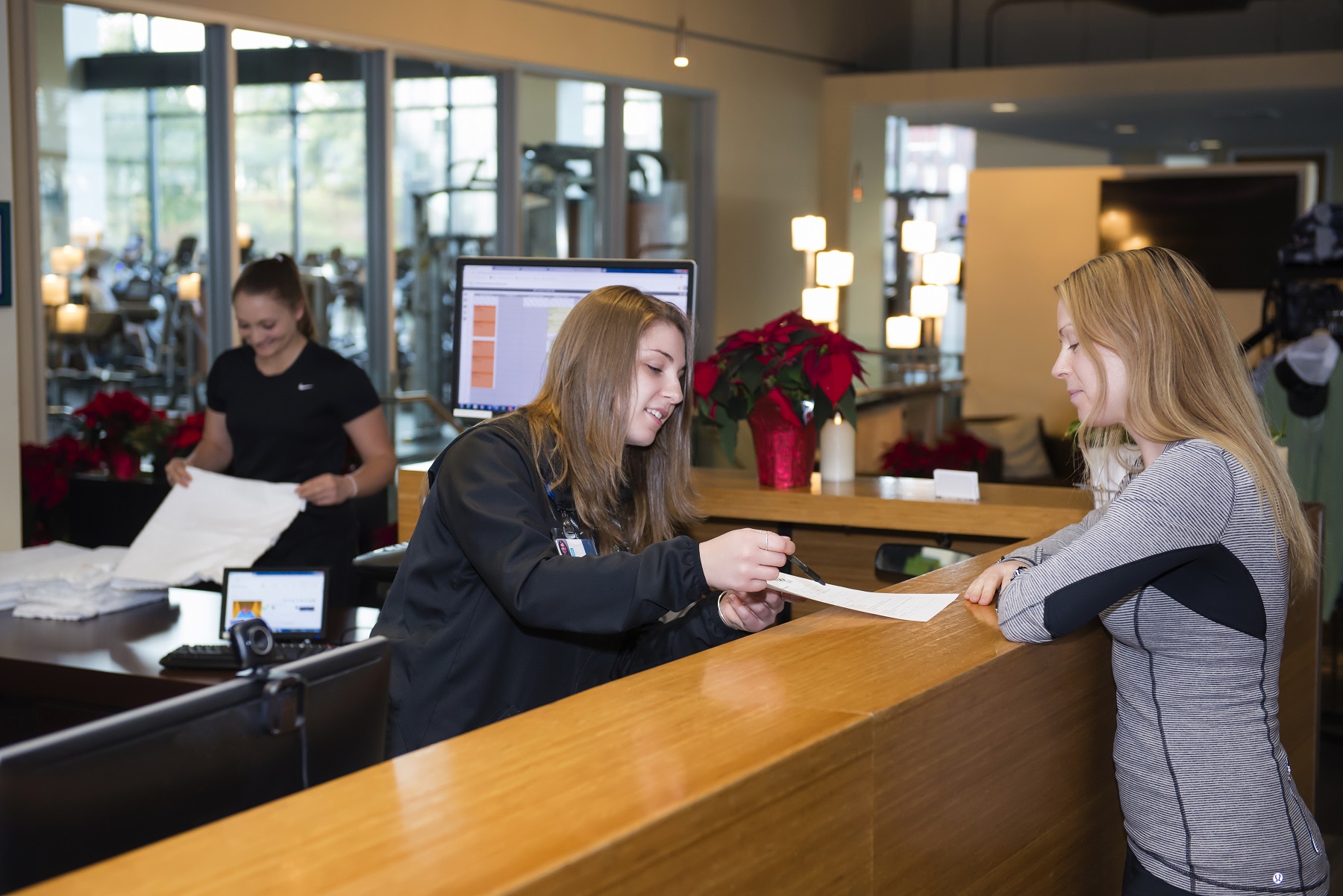 Member completing membership contract at front desk of march wellness & fitness.
