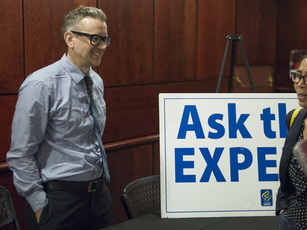 A faculty member speaks to the public at a lecture reception.
