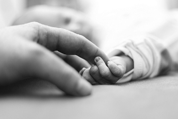 mom holding baby's hand