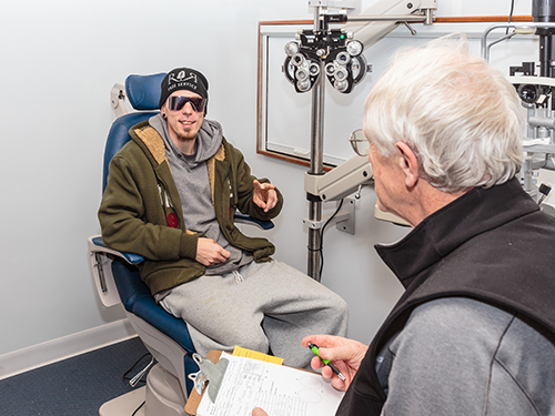 An eye doctor examining a patients on the Casey Community Outreach Program mobile clinic.