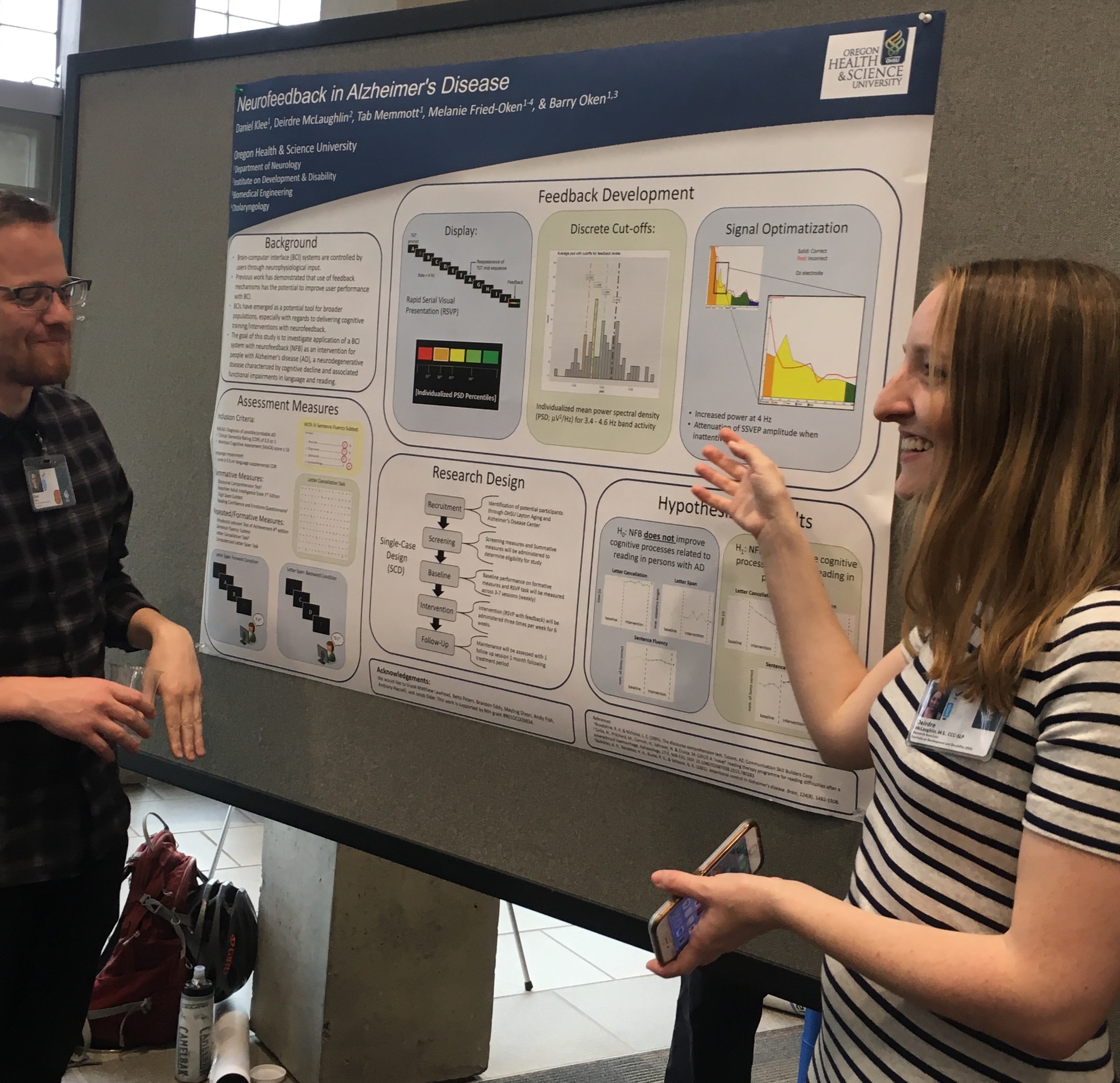 Two people presenting a research poster