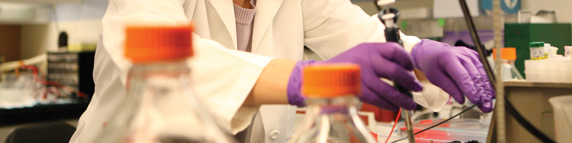 Photo of scientist pipetting
