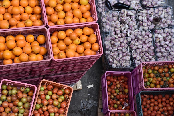 Crates of oranges, garlic and tomatoes