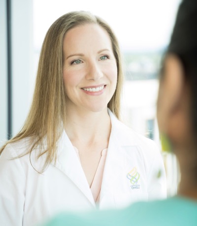 Antonia Gragg, a physician associate, talks with a patient. She is part of our neurosurgery team.