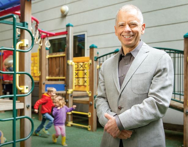 Joel Nigg on Playground with kids running in the back