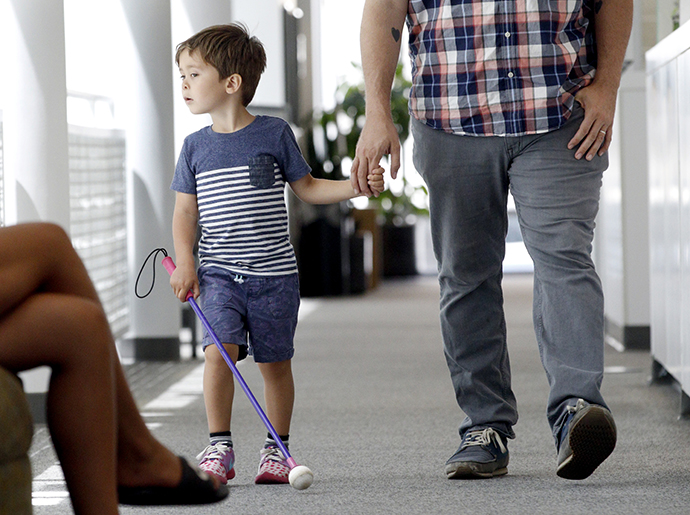 A young boy with inherited retinal disease walks with his dad. He was treated with the first FDA approved gene therapy Luxturna.