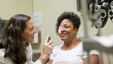 Dr. Davis doing an eye exam with a patient