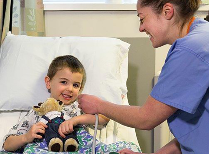 Child and nurse preparing for eye surgery
