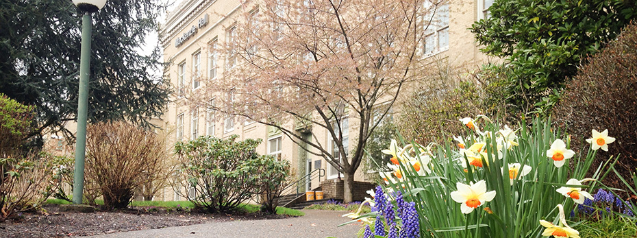Mackenzie Hall behind blooming flowers
