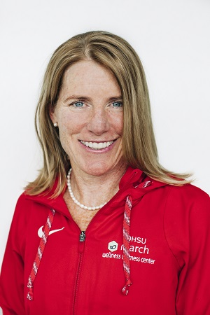 Alicia Harden with long blond hair and red jacket