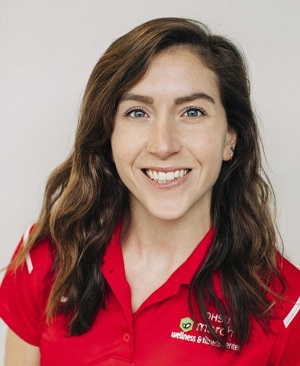 Pic of Annie Jonsson with long brown heair wearing red polo shirt