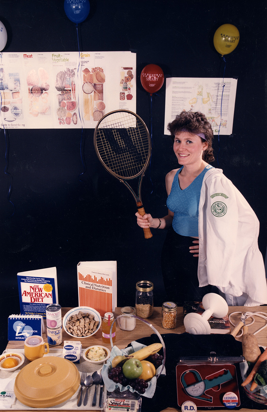 Teresa Jones, dietetic intern, poses with dietetic-related items, circa 1980s