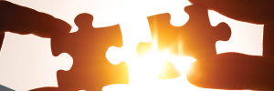 A picture of two puzzle pieces coming together