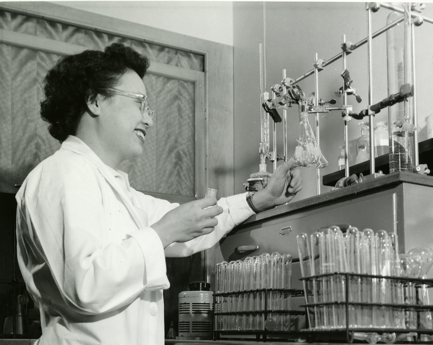 Rose Wong, Ph.D., works in a biochemistry lab with pipettes