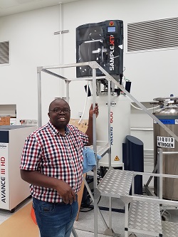 Francis Dhoro standing next to a ladder