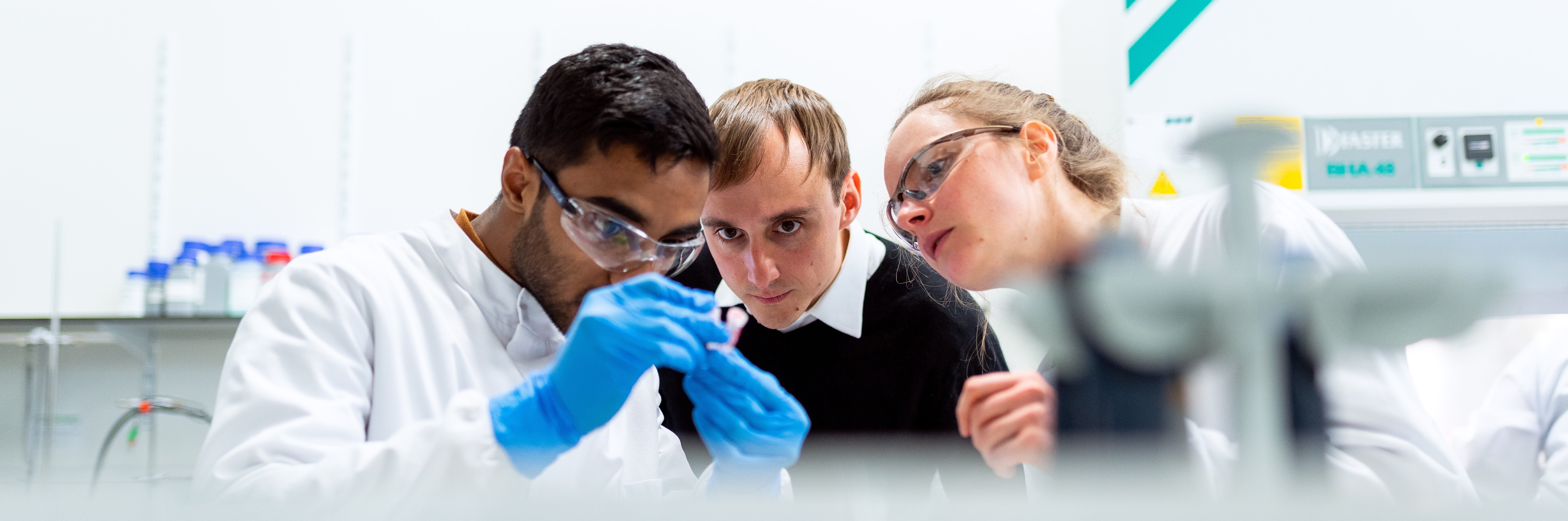 One researcher showing 2 observers a test tube