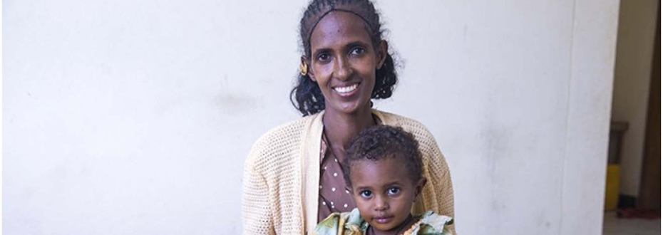A woman with her child in her lap.