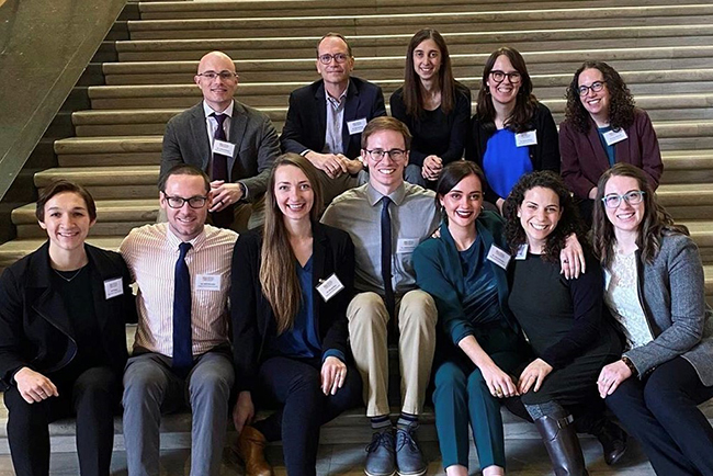 A group of 博彩网站 Pediatric Residents sitting together on stairs at the Oregon State House.
