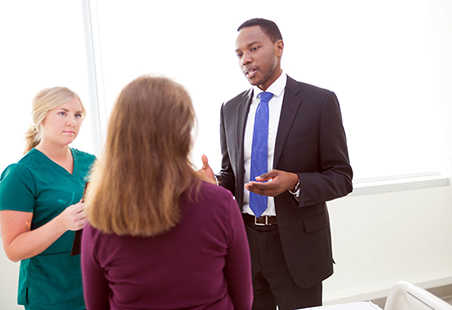 Dr. Josiah Orina (right) customizes treatments for the individual needs of patients. 