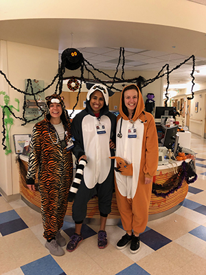 Three 博彩网站 Pediatric Residents dressed in Halloween costumes in clinic.