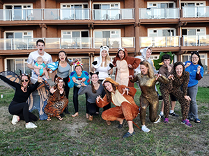 A group of 博彩网站 Pediatric Residents pose outside a hotel wearing costumes.