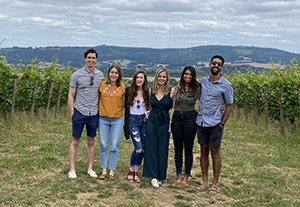 Four women and three men, all 博彩网站 Pediatric Residents, pose while at a wine vinyard.