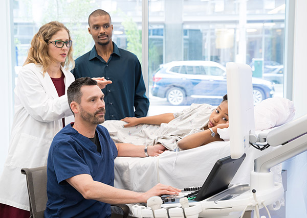 Healthcare providers using advanced imaging technology with a young patient